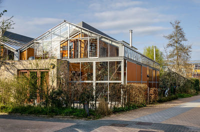 Street with ecological houses with facades mainly constructed with wood and glass