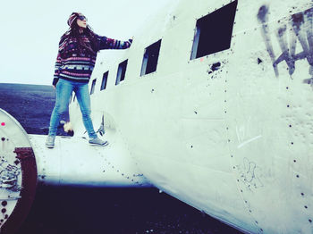 Woman standing on car