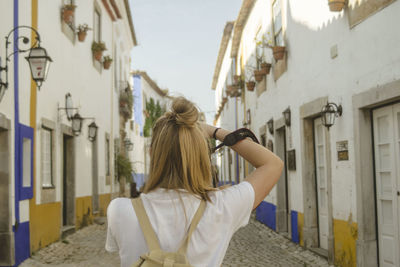 Rear view of woman on building in city