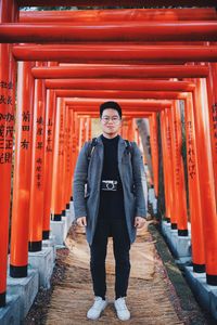 Portrait of young man standing at temple