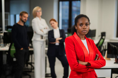 Portrait of smiling businesswoman standing in office