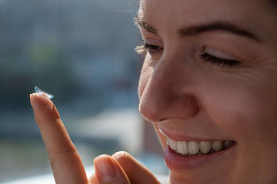 Close-up portrait of young woman against blurred background