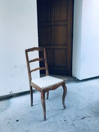 Empty chair against house