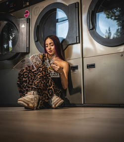 Portrait of young woman sitting in car