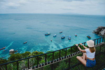 High angle view of people on sea shore against sky