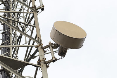 Low angle view of communications tower against sky