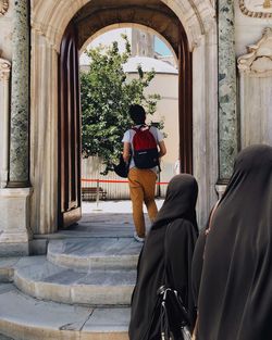 Rear view of man standing outside building