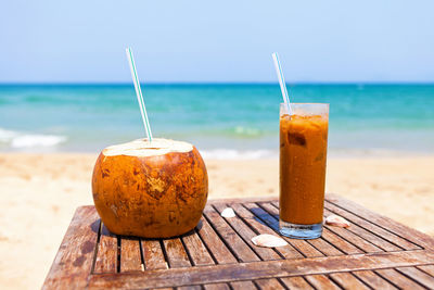 Close-up of drink on beach