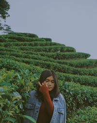 Woman standing amidst plant