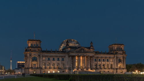 View of reichstag building against blue sky