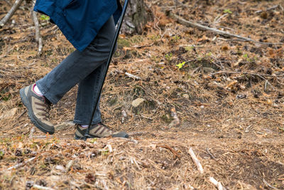 Low section of person walking on dirt road