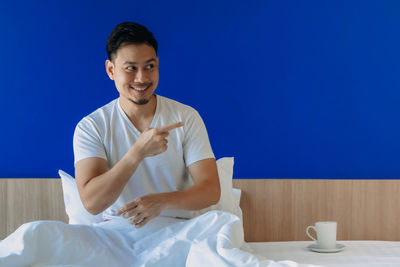 Portrait of young man sitting at table