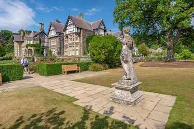 Statue in park against building