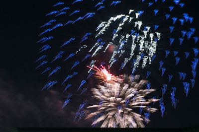 Low angle view of firework display at night