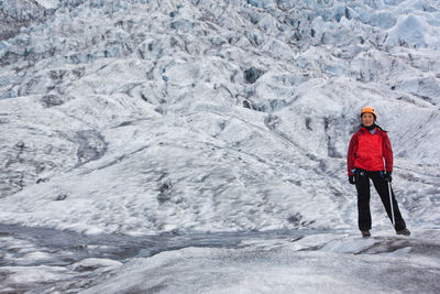 Woman hiking up sólheimajökull glacier in south iceland