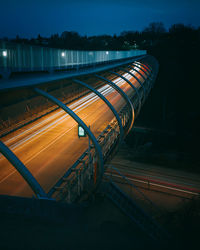 Light trails of cars driving an s-shaped modern steel bridge