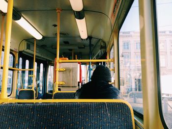 Rear view of man sitting in bus