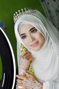 Portrait of smiling young woman wearing hijab