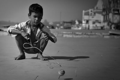 Portrait of boy playing in city