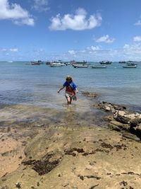 Full length of man on beach against sky