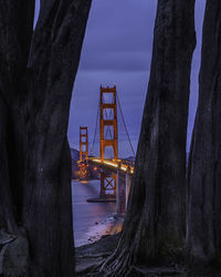 Bridge over sea against sky at dusk