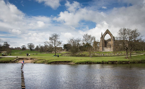 Scenic view of stepping stones in bolton abbey  against blue sky with clouds 