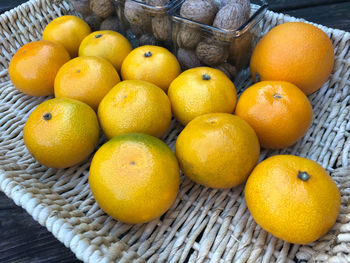 Close-up of orange fruits in basket on table