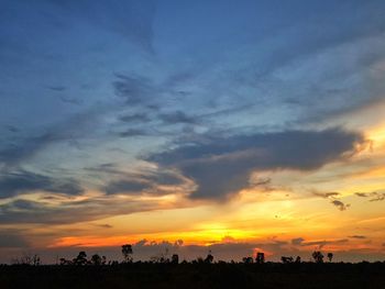 Scenic view of silhouette landscape against orange sky