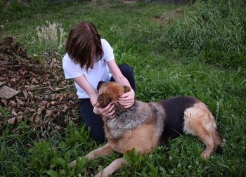 Woman with dog on field