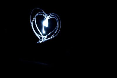 Close-up of light bulb over black background