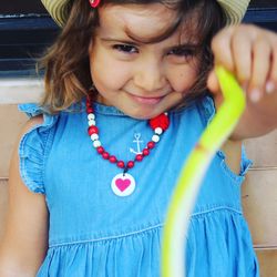 Portrait of cute girl holding toy