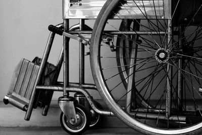 Close-up of bicycle wheel against wall