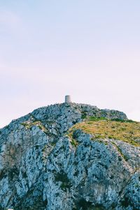 Rock formations by building against clear sky