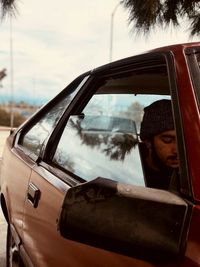 Reflection of man on car window