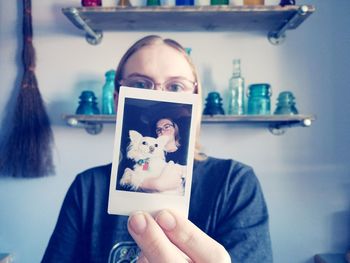 Portrait of woman holding instant print transfer