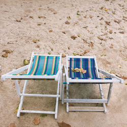 High angle view of empty chair on beach