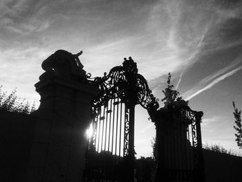 Low angle view of silhouette building against sky