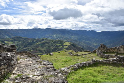 High angle view of mountains against cloudy sky