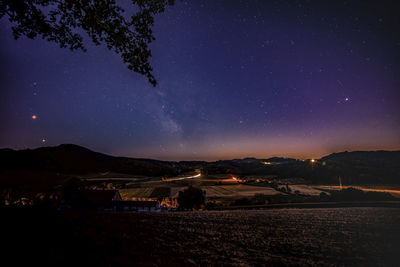 Scenic view of landscape against sky at night