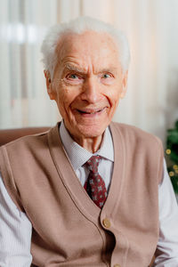 Portrait of man standing against window