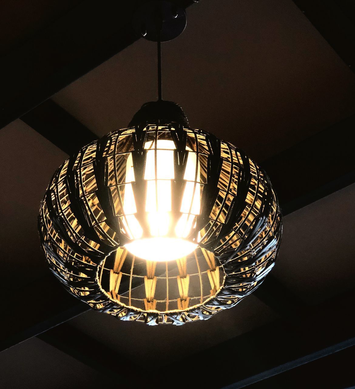 LOW ANGLE VIEW OF ILLUMINATED PENDANT LIGHT HANGING FROM CEILING