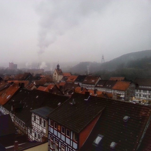 building exterior, architecture, built structure, residential structure, roof, residential building, residential district, city, house, sky, cityscape, crowded, high angle view, town, townscape, cloud - sky, mountain, community, day, weather