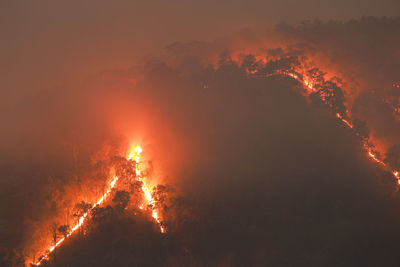 A mountain with a forest fire in forest fires at night look sad, the cause of pm 2.5 smoke 