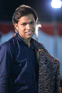 Portrait of young man standing outdoors