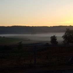 Scenic view of field against sky during sunset