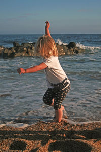 Rear view of woman on beach