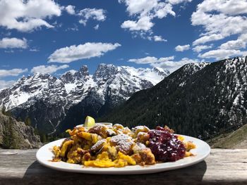 High angle view of food on table in mountains against sky