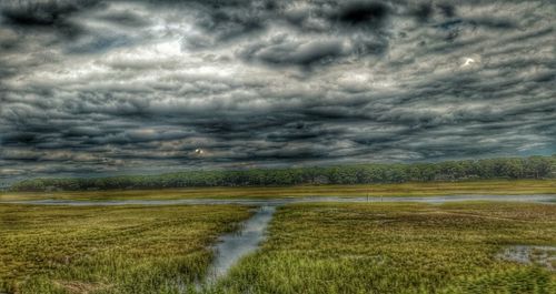 Scenic view of landscape against cloudy sky