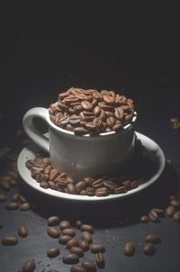 Close-up of coffee beans on table against black background