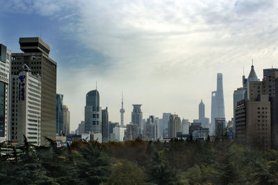 City skyline against cloudy sky